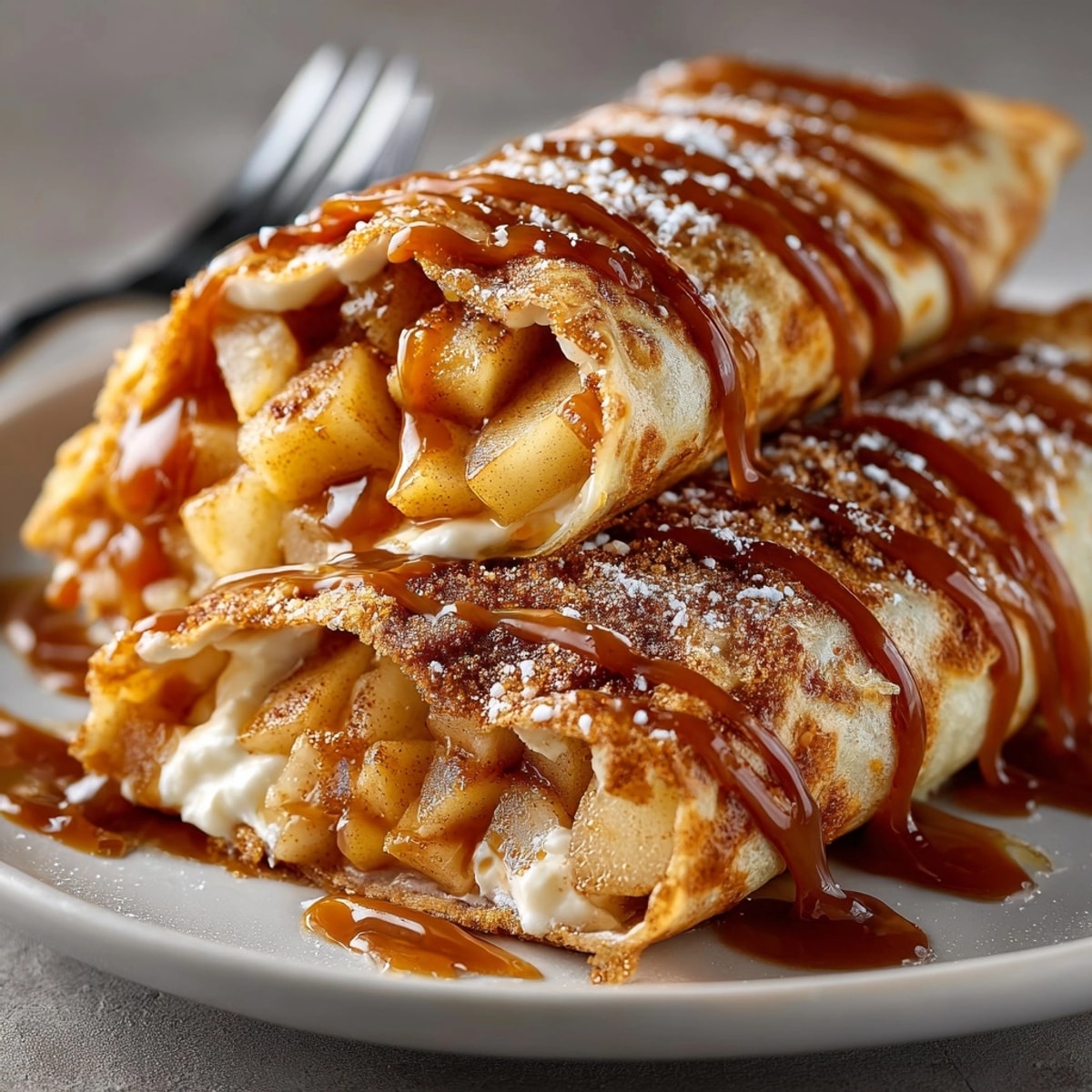 Golden Fall Caramel Apple Dessert Wraps served warm, oozing caramel alongside tender cinnamon apples.