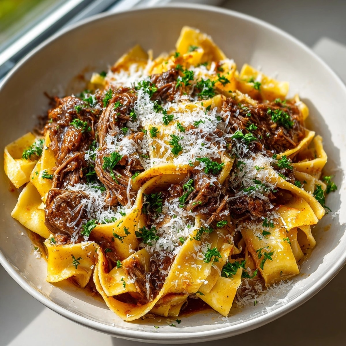 Tender short rib pasta, a rich Italian-American dish, glistening with bone marrow butter.