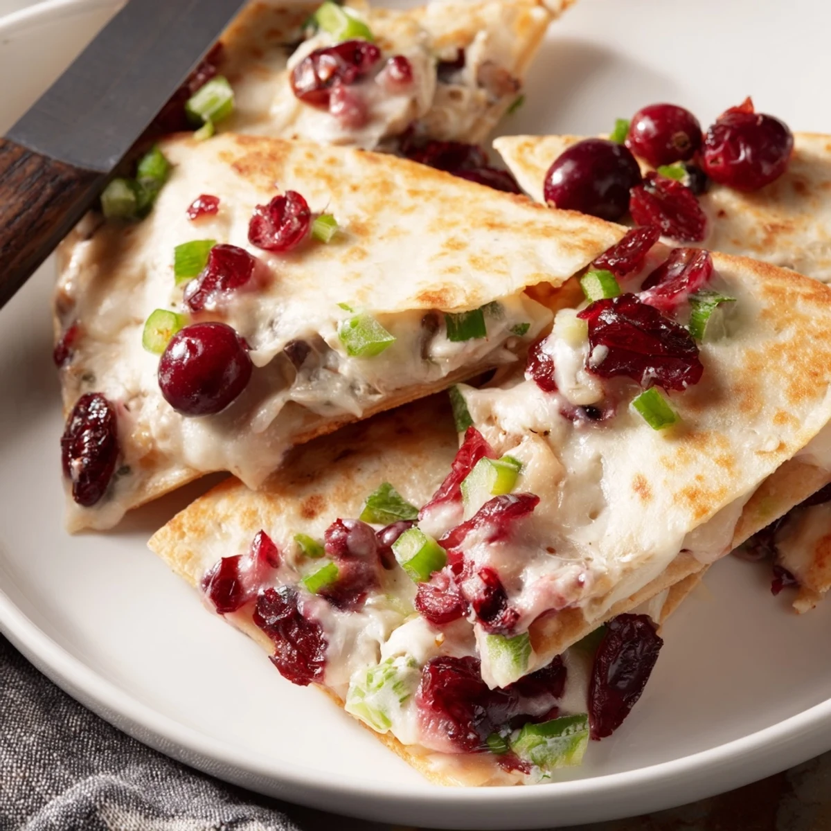 Crispy quesadillas filled with cranberry jalapeño dip, perfect for festive gatherings.  
