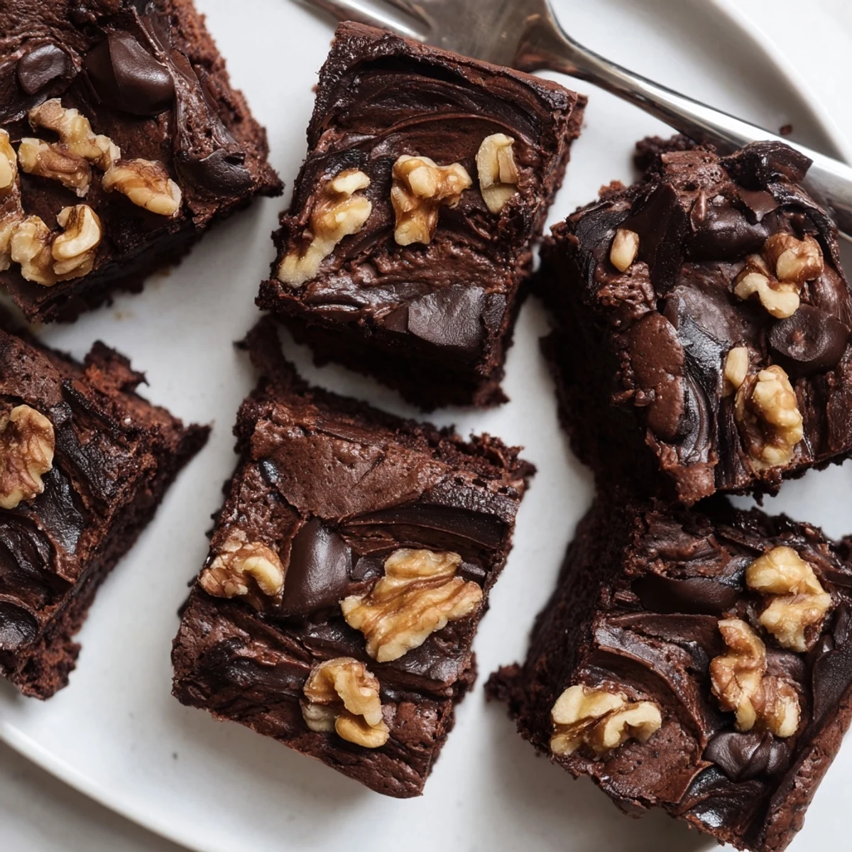 Rich Zero-Waste Brownies using nut-milk pulp, topped with chocolate chips and nuts.