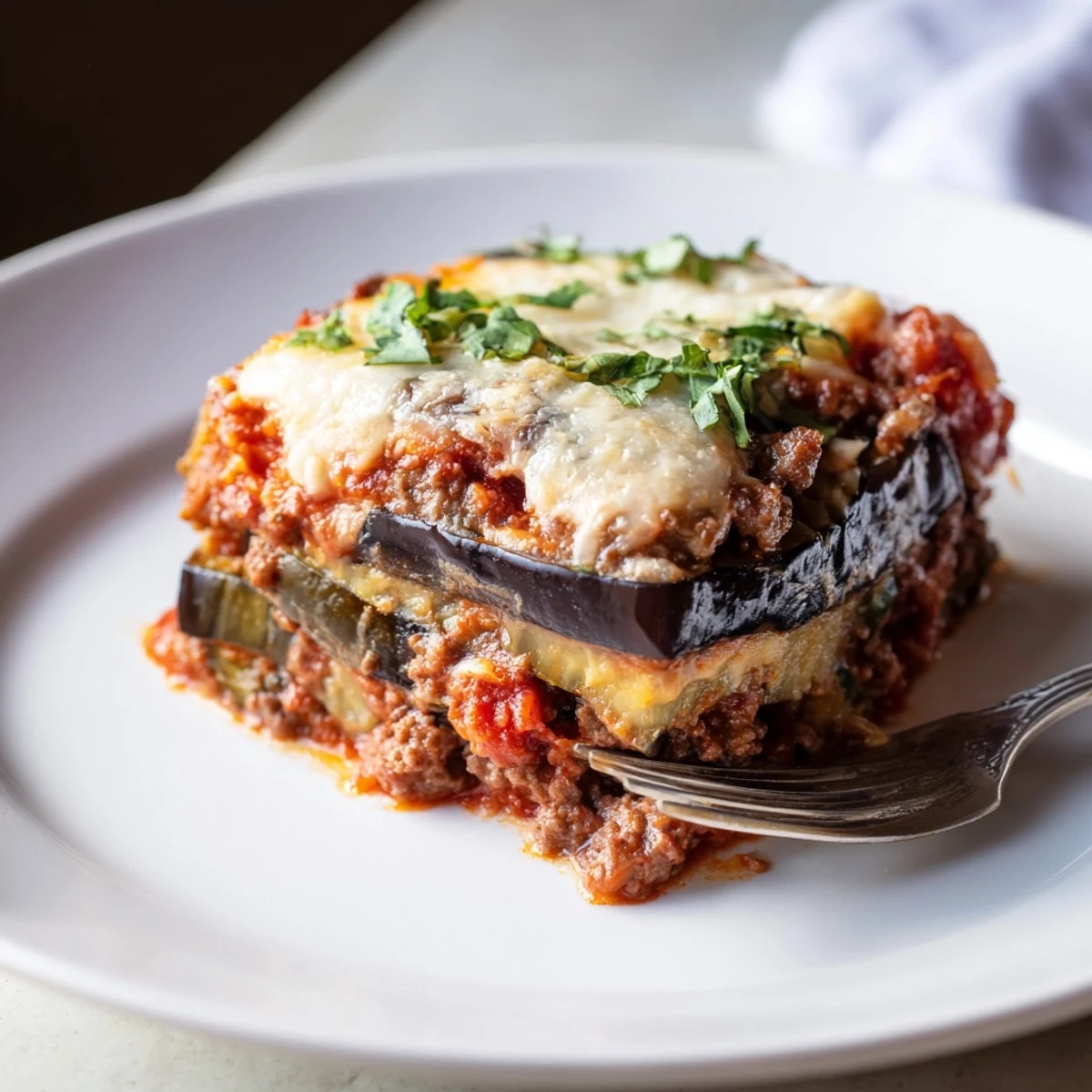 A bubbling dish of homemade Moussaka, showcasing tender eggplant and flavorful meat sauce.