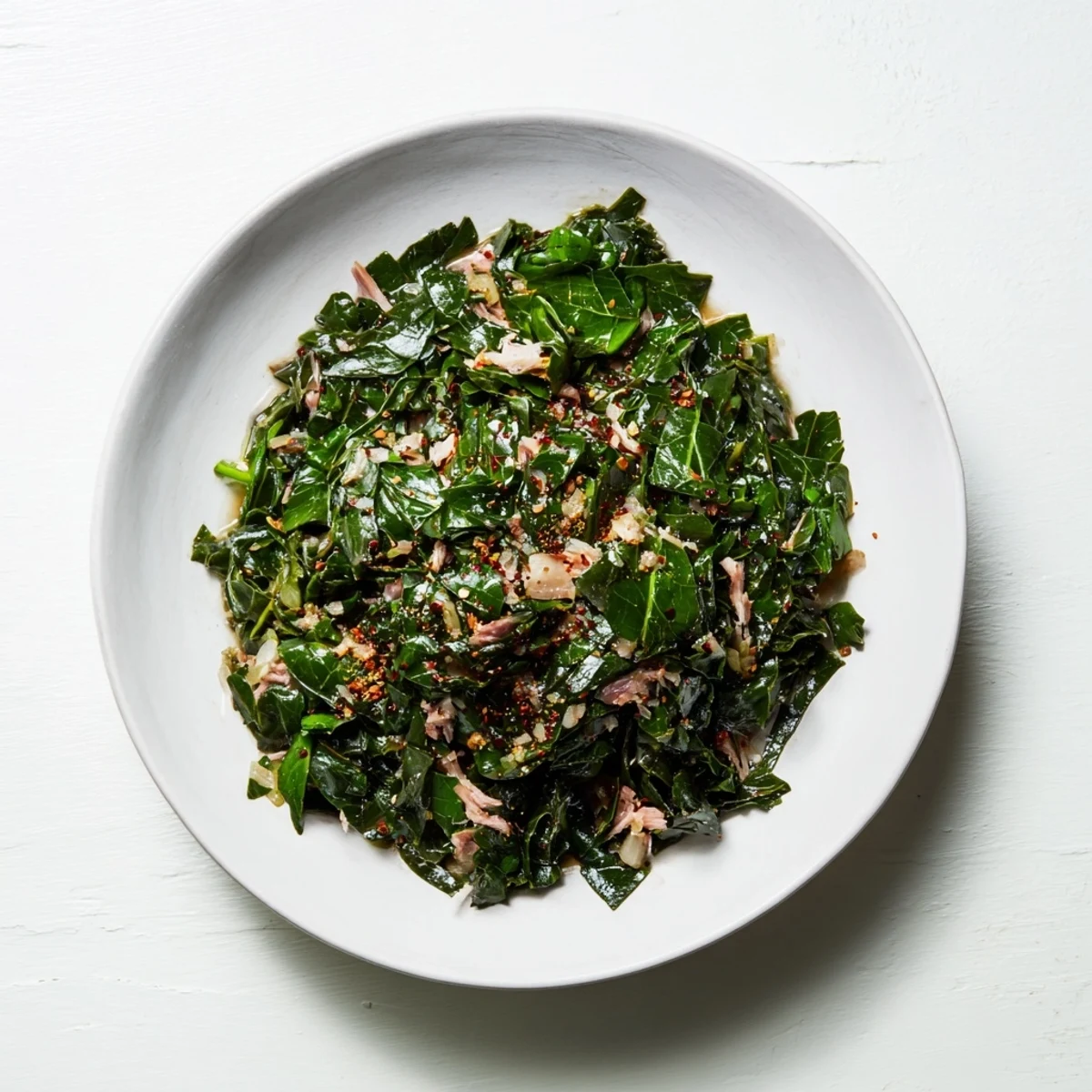 Southern-style collard greens with smoked turkey, featuring tender greens and smoky turkey visible in a hearty bowl.