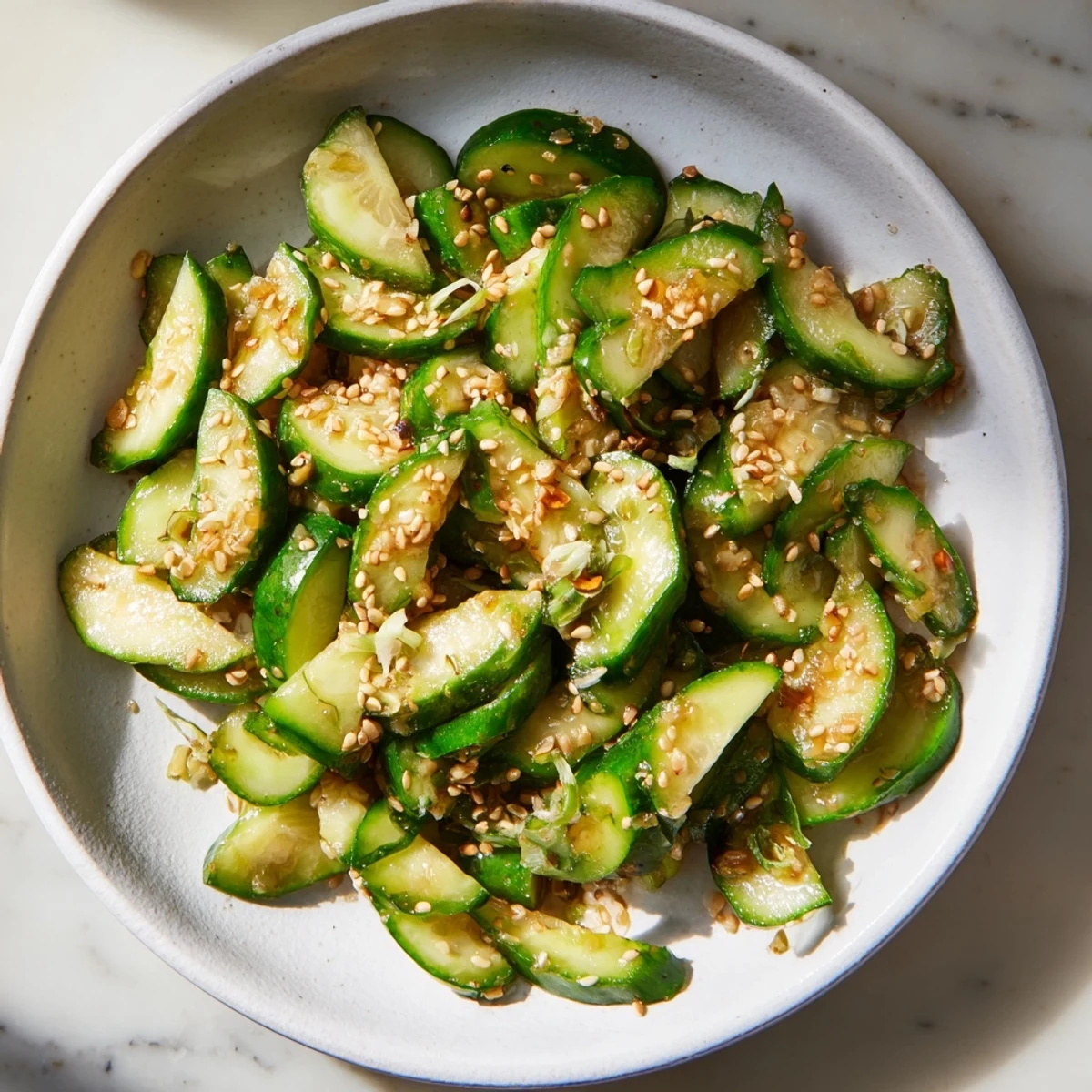 Close-up of a refreshing Cucumber Shaker salad, seasoned with rice vinegar and MSG, ready to eat.