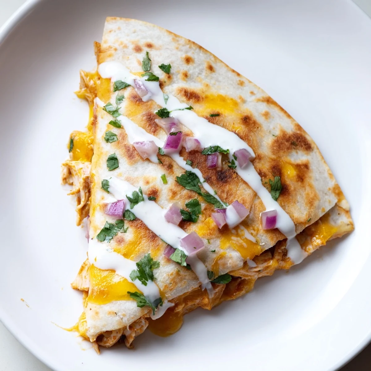 Warm, melty Buffalo Chicken Quesadilla with crispy edges and a flavorful buffalo chicken filling.