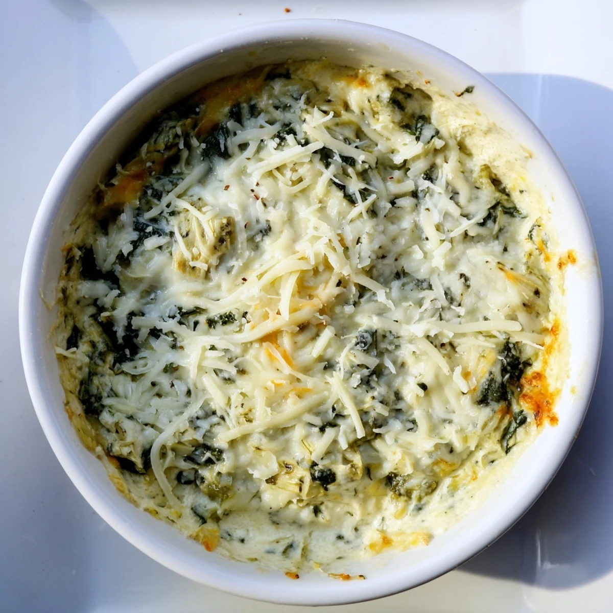 Steaming, bubbling Cheesy Spinach Artichoke Dip, perfect for scooping with crisp tortilla chips at a party.
