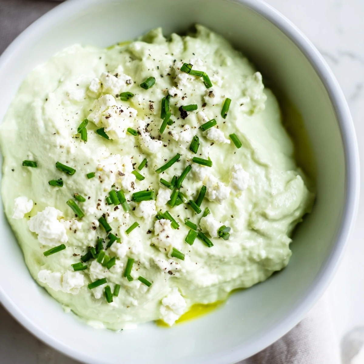 Creamy Avocado Cottage Cheese Dip, a vibrant green dip ready to serve with fresh vegetables and crackers.