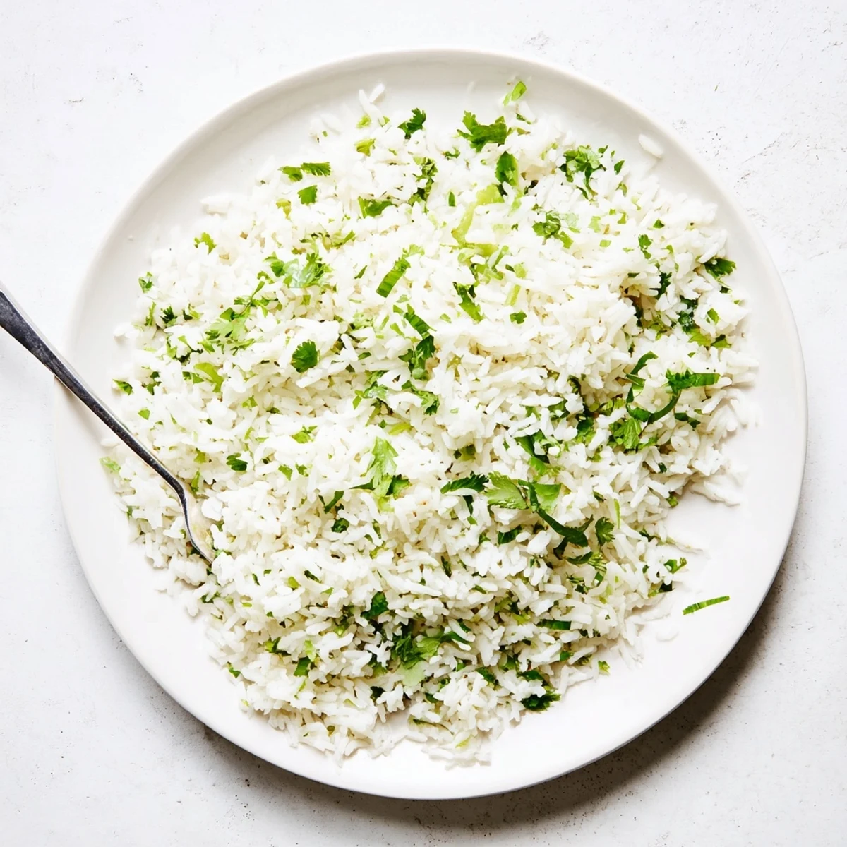 Fluffy long-grain rice tossed with vibrant green cilantro and bright lime zest for a zesty side dish.  