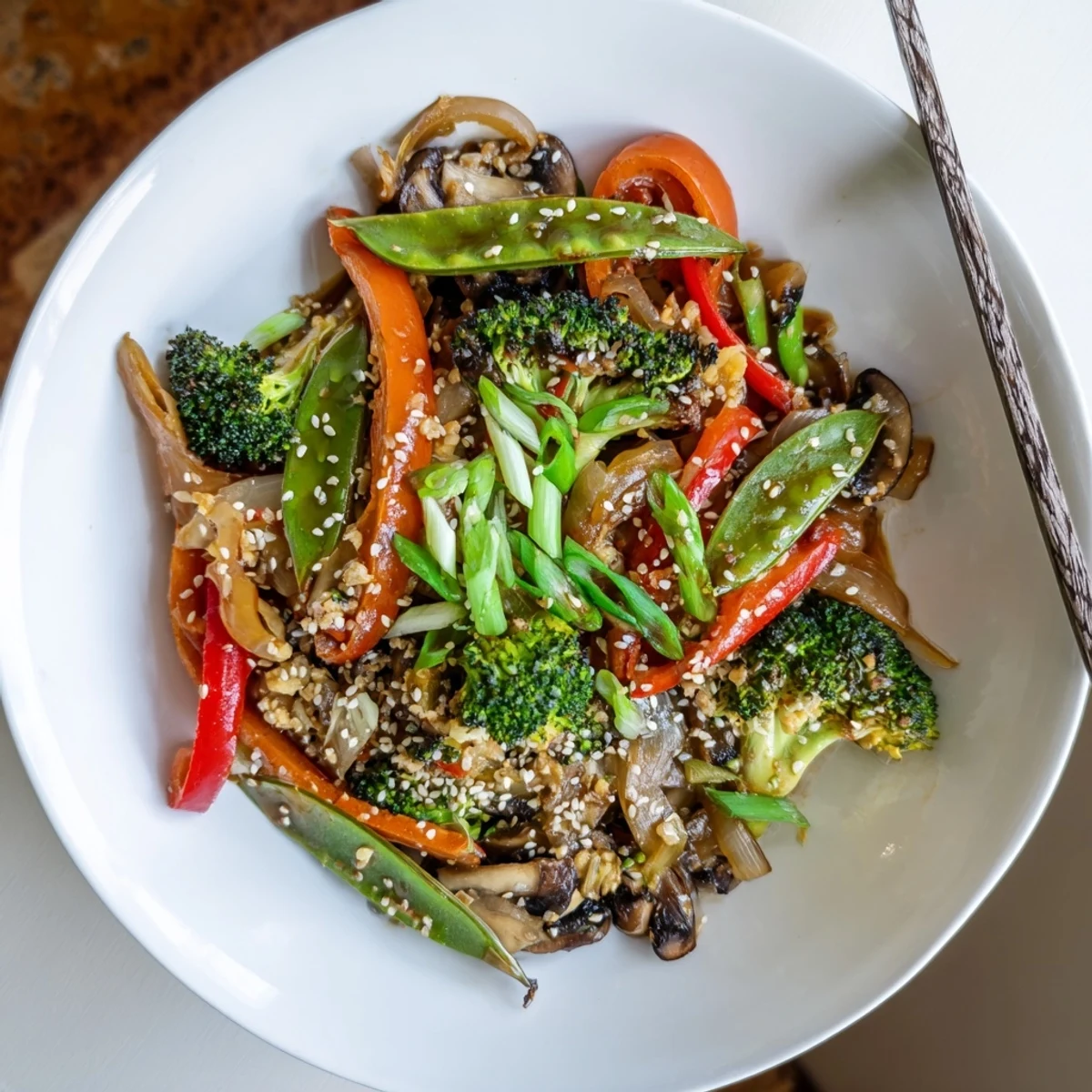 An easy vegan meal: colorful vegetables tossed with a tangy ginger-soy glaze in a hot wok for dinner.