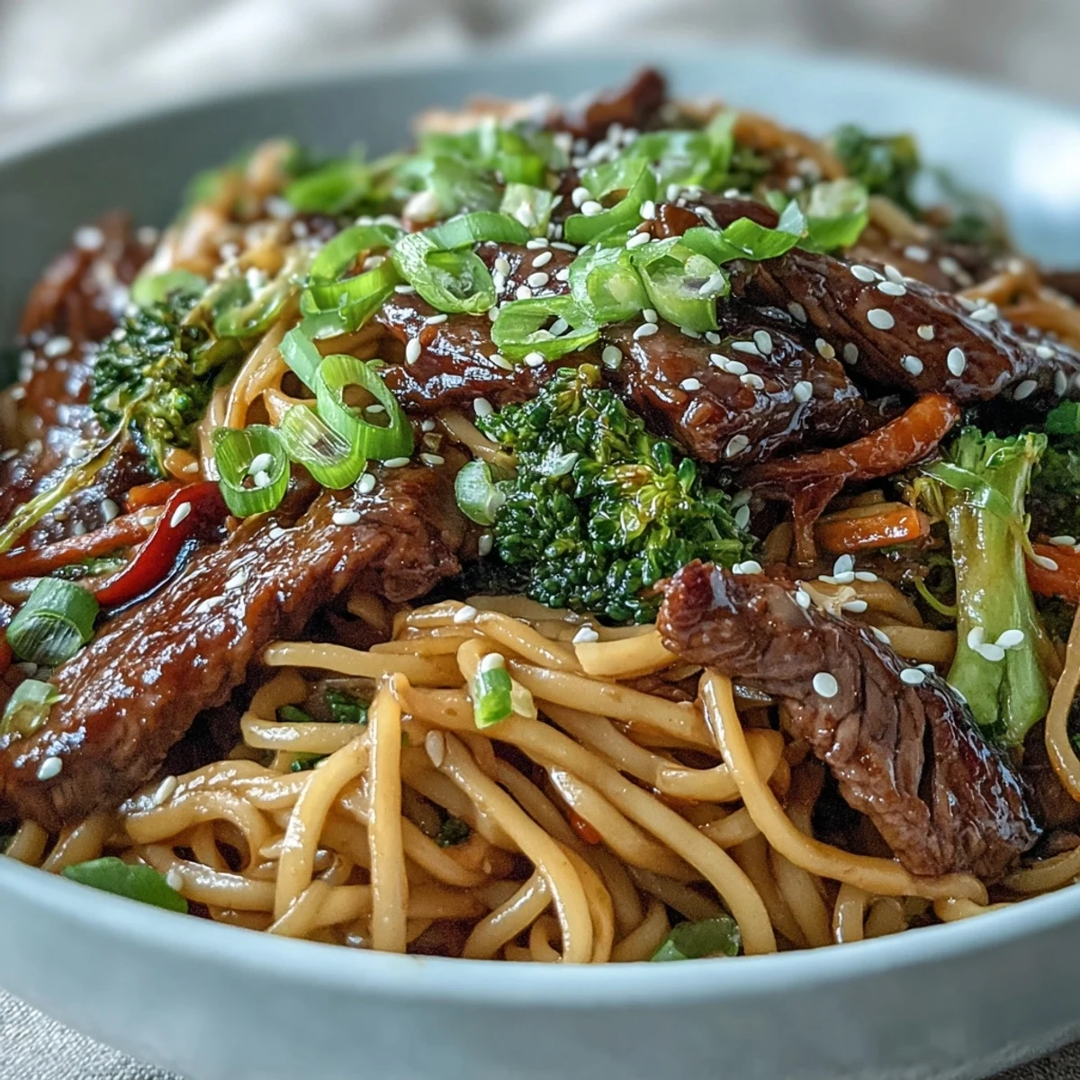Glossy soy-glazed Korean Beef Noodles with tender flank steak and crisp broccoli served over silky rice noodles.