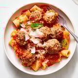 Hearty Italian Meatball Pasta Skillet topped with melted cheese and fresh basil.   