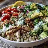 Tender rotisserie chicken and crisp broccoli florets combine in this colorful Rotisserie Chicken Bowl, drizzled with tangy tzatziki sauce.