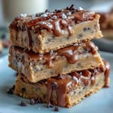 Chewy, golden cookie bars studded with colorful candies and drizzled with melted white chocolate, perfect for sharing at graduation parties.  