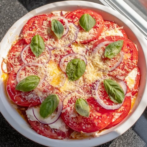 Speedy Feta-Free Tomato Bake with bubbling mozzarella, golden Parmesan, and fresh basil garnish.