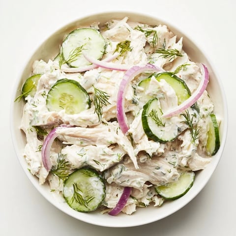 Crisp sliced cucumbers and tender shredded chicken tossed in a creamy dill yogurt dressing in a chilled bowl.  