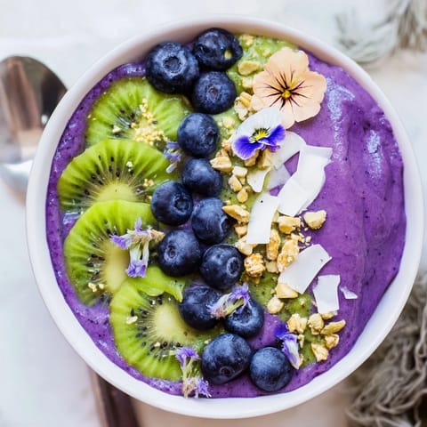 Delightful breakfast recipe with creamy texture, colorful fruits, and crunchy granola.  