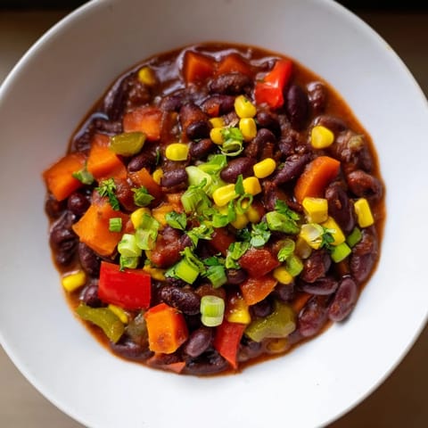 Hearty veggie chili with vibrant colors and rich aromas; a perfect vegan weeknight dinner.
