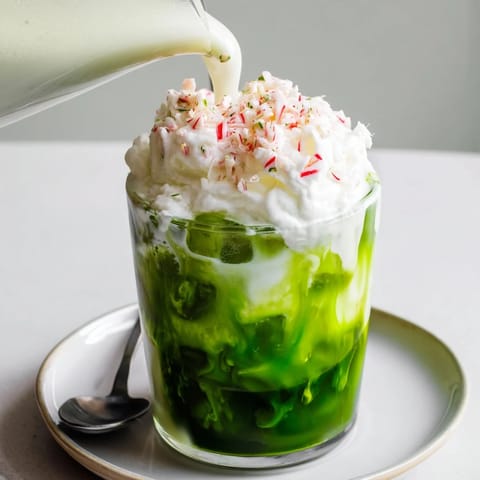 A refreshing Sugar-Free White Chocolate Candy Cane Iced Matcha, perfect for a festive treat with crushed candy canes.