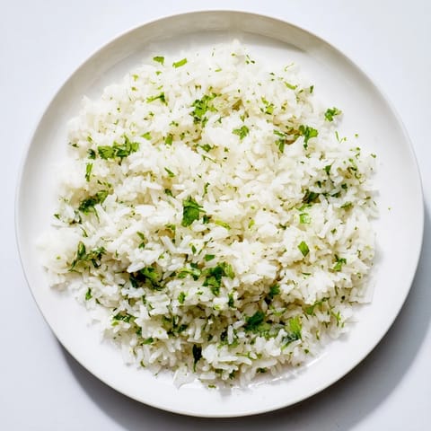 Fluffy Cilantro Lime Rice, pictured in a bowl, ready to be served alongside delicious tacos.