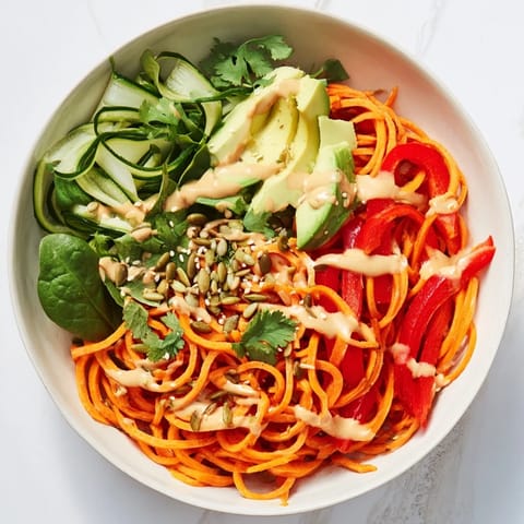 Enjoy a refreshing Carrot Noodle Skincare Bowl filled with spiralized carrots, a vegan delight, ready to eat.