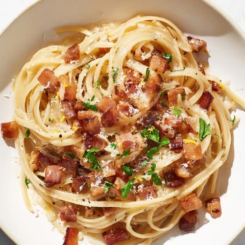 Enjoy the richness of Crispy Bacon Linguine, with crispy bacon, garlic, and freshly grated Parmesan cheese.